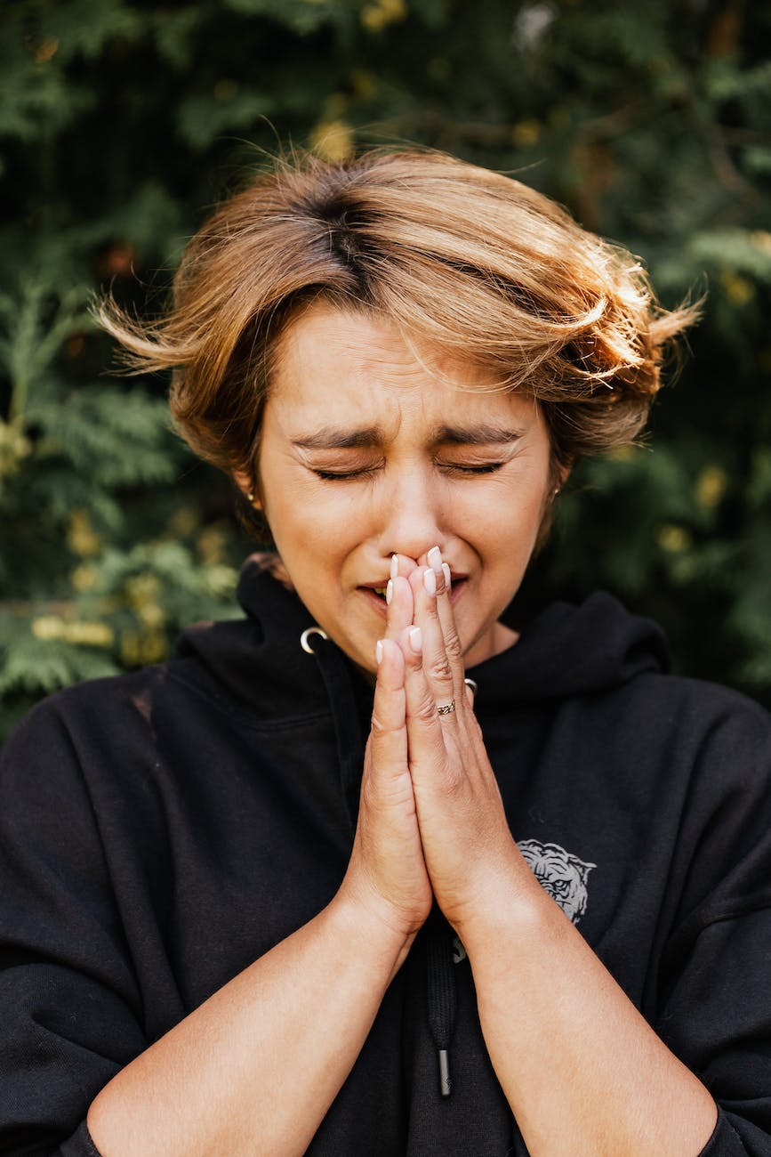 close up photo of desperate praying woman