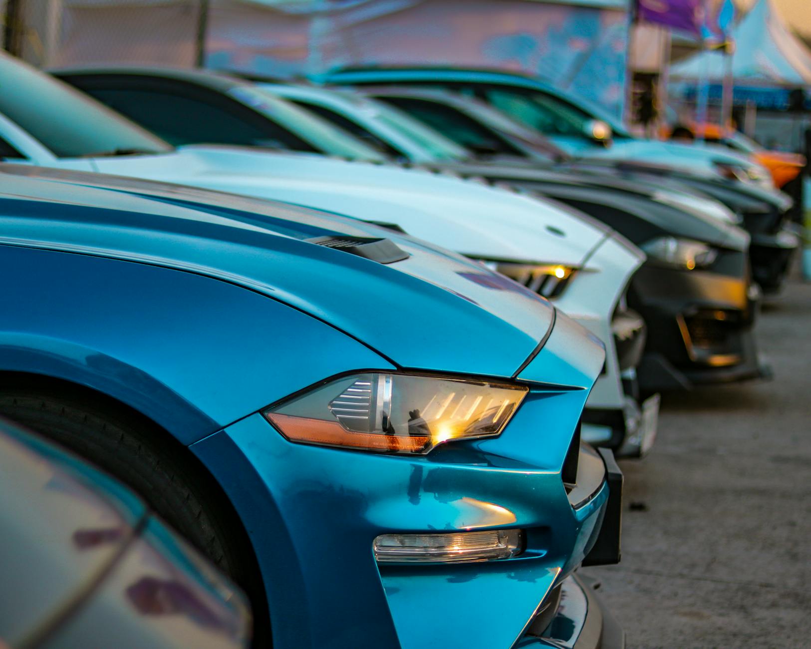 a row of cars parked in a parking lot