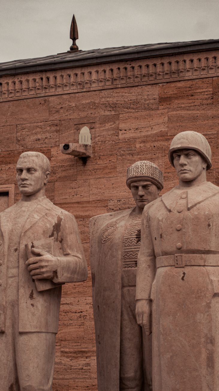 statues against red brick wall
